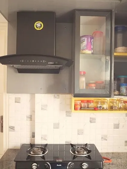 Another angle of the kitchen with yellow accents, demonstrating how small details can make a big impact. The design is both functional and personalized.