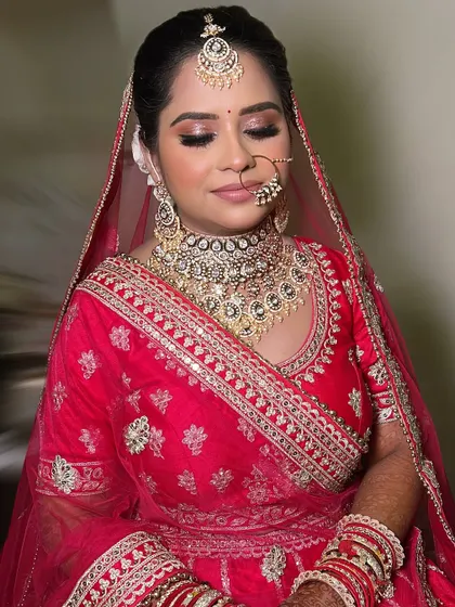 A close-up of Divya's flawless makeup. The skin is glowing, the eyes are defined, and the lip color is the perfect shade to complete the look.