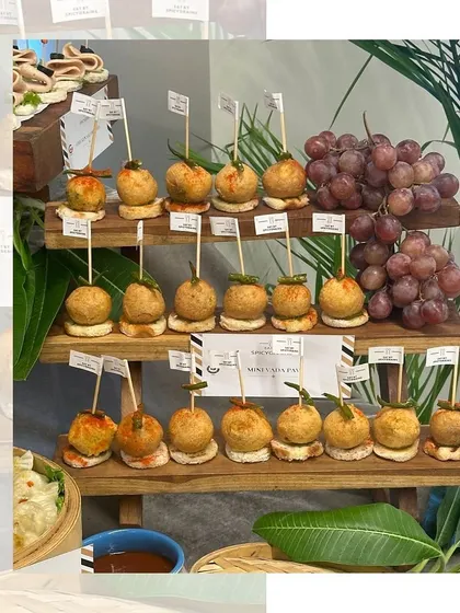 Another look at our mini Vada Pavs, arranged on a tiered wooden stand. A perfect bite-sized snack for any occasion.