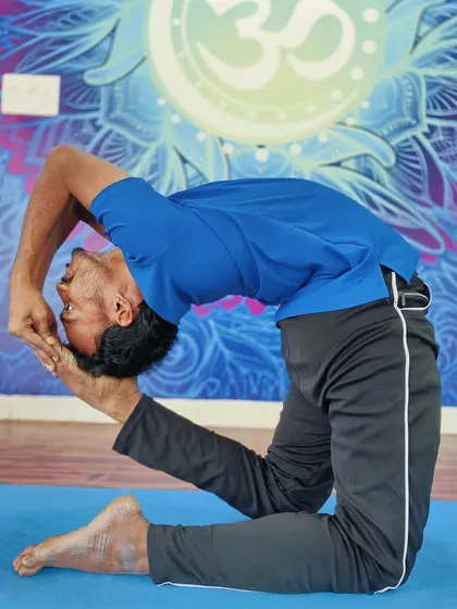 An extreme backbend, Kapotasana (Pigeon Pose), demonstrating an advanced level of spinal flexibility and openness.