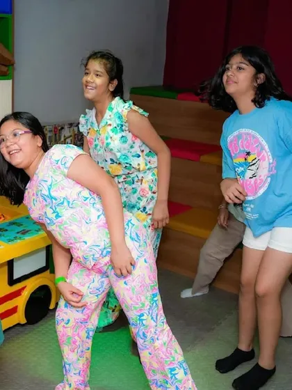 Friends having a laugh during a party game.