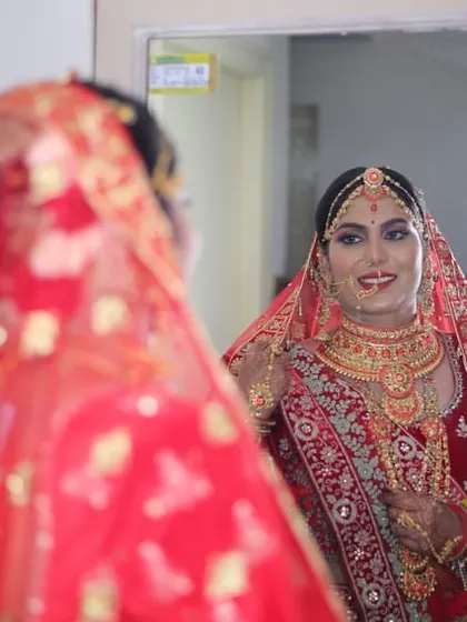 The mirror shot every bride loves. It reflects her complete transformation and the happiness of seeing her final wedding look.