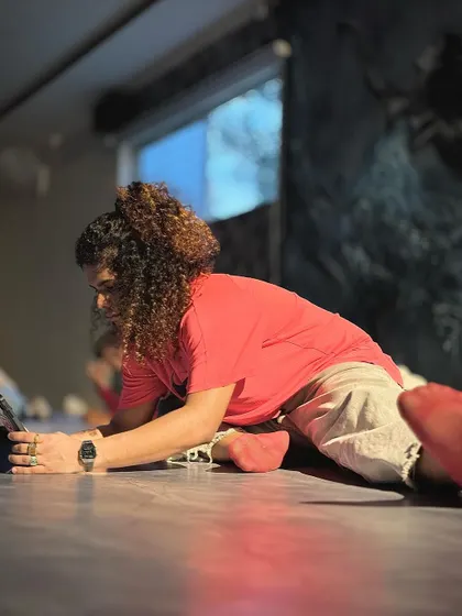 Our instructor demonstrates a deep stretch, showing the importance of flexibility and mobility that we emphasize in our classes.