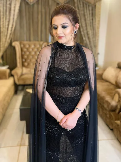 The finished look, with a dramatic black smokey eye and a soft nude lip, creating a balanced and stunning party makeup style.