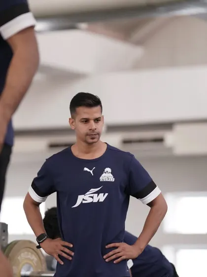 A candid shot from a training session, observing the players with a critical eye.