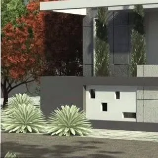 A detailed view of a villa's exterior, highlighting the interplay between architectural form and softscape elements. We use structured planters and ornamental grasses to complement the building's modern lines.