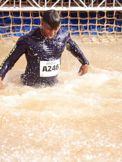 Emerging from the muddy water obstacle at Devil's Circuit. This is where mental toughness becomes more important than physical strength.