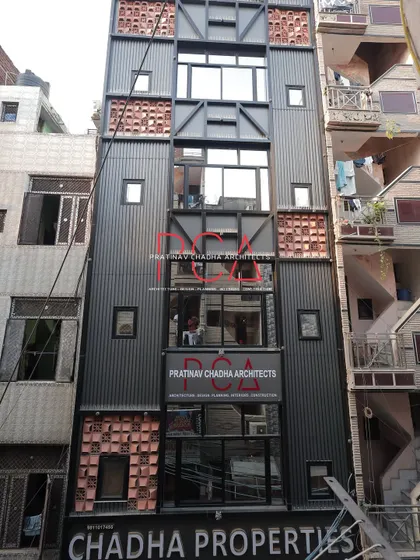 A full daytime view of the Chadha Properties office facade, showcasing the entire four-story elevation and its industrial-chic aesthetic.
