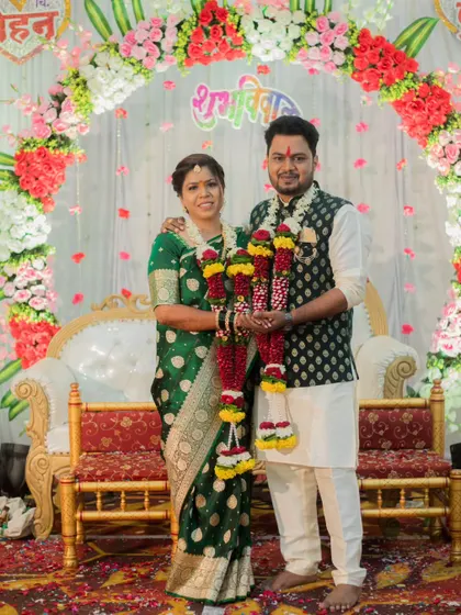 The couple proudly displays their floral garlands (haars) after the completion of their engagement ceremony.