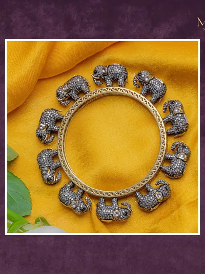 A truly unique piece that celebrates our culture. This kada features intricately crafted elephants adorned with diamonds, set against a classic gold bangle. It's a statement of heritage and artistry.