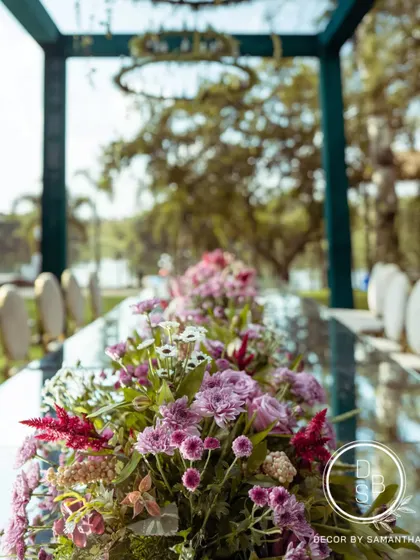 A close-up of the floral tablescape, showing the beautiful mix of lilac, pink, and white flowers that ran down the center of the mirror-top table.