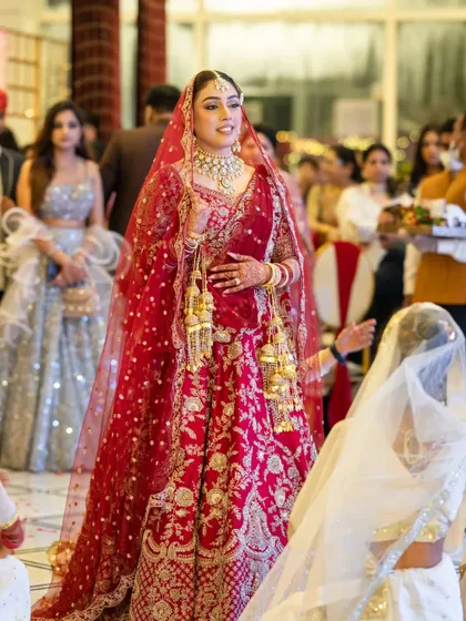 A candid shot of the bride walking down the aisle, her expression full of anticipation and happiness.