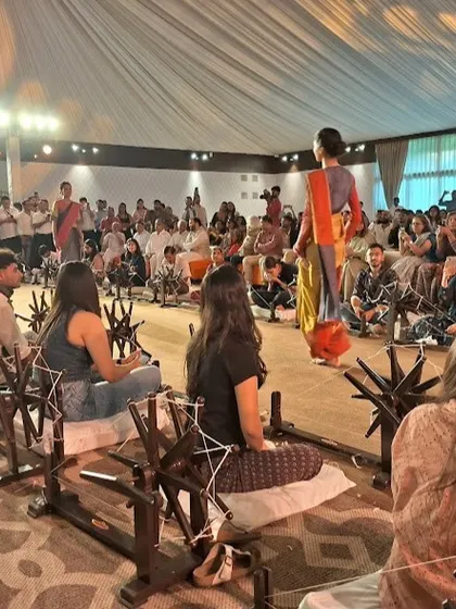 Our students seated in the front row at the Khadi Couture show, observing the runway while participating in the Charkha Baithak.