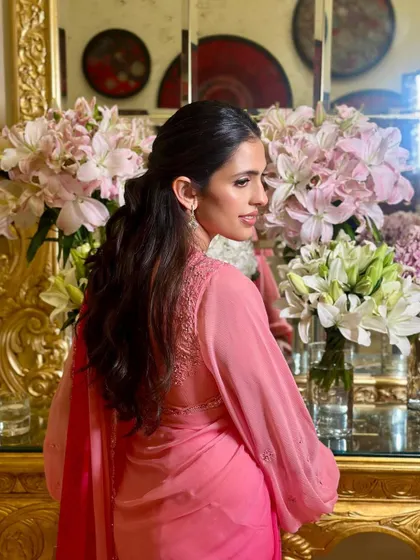 The back view of the pink Manish Malhotra saree, showing the delicate embroidery and the elegant hairstyle we chose to complement it.