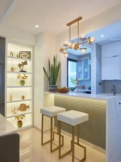 A stylish breakfast bar with fluted paneling and backlit shelving, creating a perfect spot for quick meals or coffee in this Lodha Complex home.