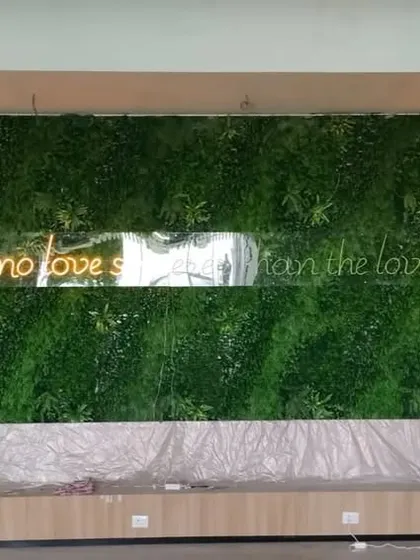 We installed this large artificial green wall as a backdrop in a restaurant, featuring a neon quote about food. It creates a fantastic feature wall and a popular spot for photos.