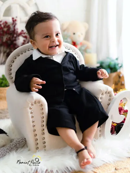 A close-up of pure happiness. This little boy's bright, happy smile is the star of his first birthday photoshoot.