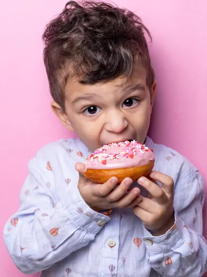 Just look at that bite. My fluffy, eggless donuts are a huge hit with the little ones, especially when they get to decorate them with pink frosting and sprinkles.
