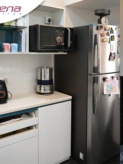A versatile kitchen corner solution. We created a dedicated counter for appliances like the microwave and coffee maker, with custom drawers below for easy access to pantry items.