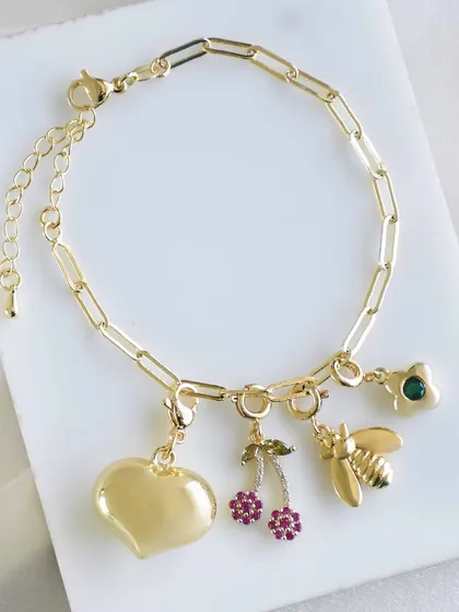 A sweet and whimsical charm bracelet with a puffy heart, sparkling cherries, a honeybee, and a flower charm.