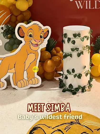 Meet Simba, the baby's wildest friend! A life-sized cutout of Simba from The Lion King added a playful and recognizable touch to this jungle-themed first birthday party.