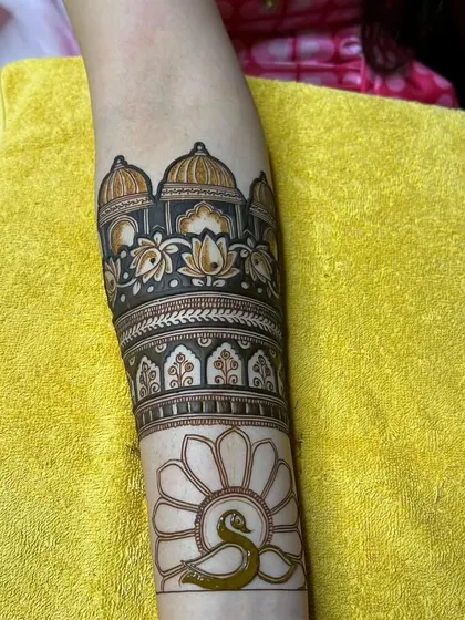 The start of a larger arm piece, featuring a palace and a simple peacock outline waiting to be filled.