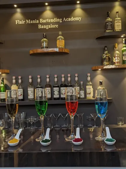 A beautiful display of our molecular mixology work, featuring colorful drinks and caviar spoons, ready to be served.