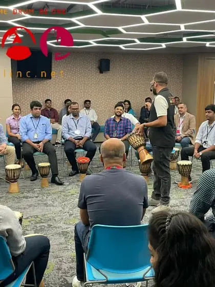 A close-up of a corporate training session. You can see the participants listening intently to the facilitator, a crucial first step before they can contribute their own voice to the group's rhythm.