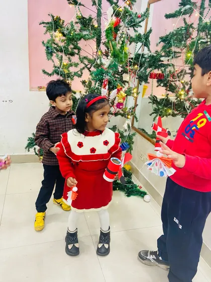 A candid moment of kids enjoying the Christmas workshop and showing each other their creations.