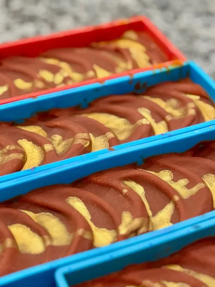 A close-up of the Rainbow soap loaves in their molds, just before being taken out to cut. The texture on top is created by hand.