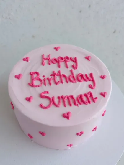 A simple and sweet pink birthday cake with piped hearts, a classic Pinterest-style design.