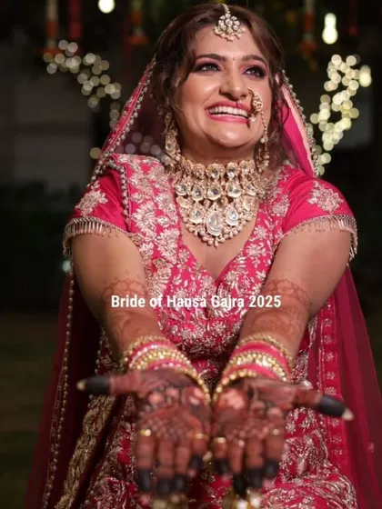 A joyful bride showing off her beautifully stained hands. Her open, happy expression and the rich color of her mehendi are the perfect combination.