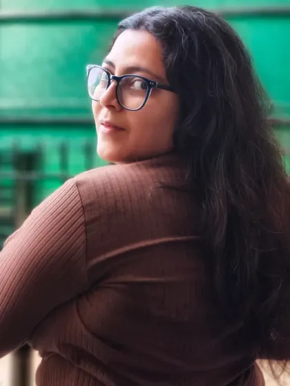 An over-the-shoulder self-portrait with a confident look. My personal photography is about self-expression and being proud of who I am.