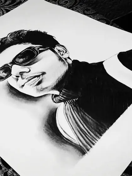 A self-portrait sketch in black and white. I experimented with a low angle and strong shadows to create a dramatic effect.