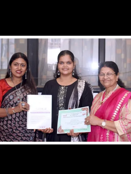 Presenting a certificate of completion to a proud student. Her hard work and practice have paid off beautifully.