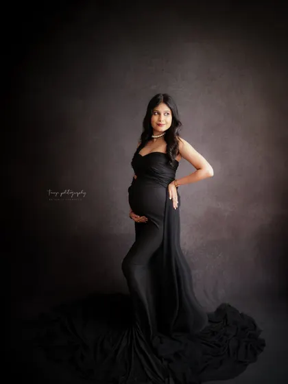 A duplicate of image 215, this dramatic portrait in a black gown against a moody background is both powerful and glamorous.