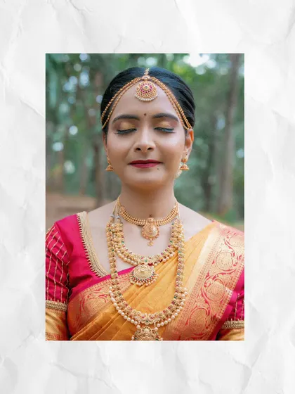 A beautiful close-up of the bride in her traditional South Indian wedding attire, her eyes closed in a moment of peaceful contemplation.
