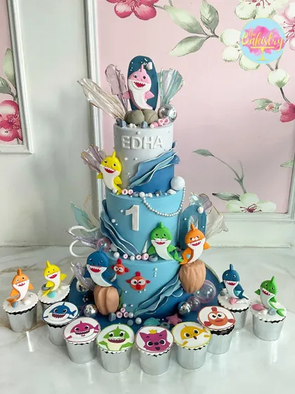 A magnificent Baby Shark cake for Edha's first birthday, complete with a whole school of shark-themed cupcakes for the guests.