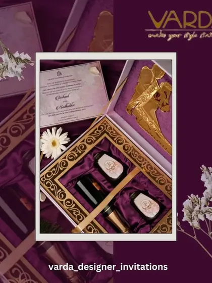 This custom invitation box showcases a luxurious purple satin interior with compartments for perfume bottles and other gifts. The design is a perfect example of how we can tailor a hamper to your specific theme and gifting needs.