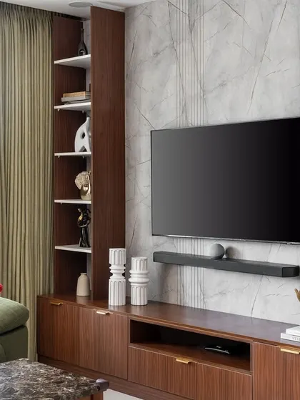Another angle of the 'Flux Abode' media unit, highlighting the asymmetrical shelving and the contrast between the dark wood and light interior.