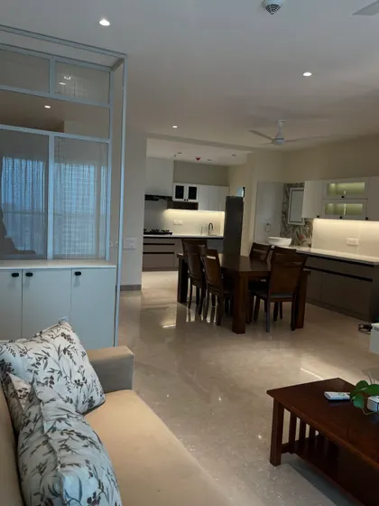 An open-plan living and dining area designed for seamless flow. The neutral color palette and clean lines create a spacious and calming environment.
