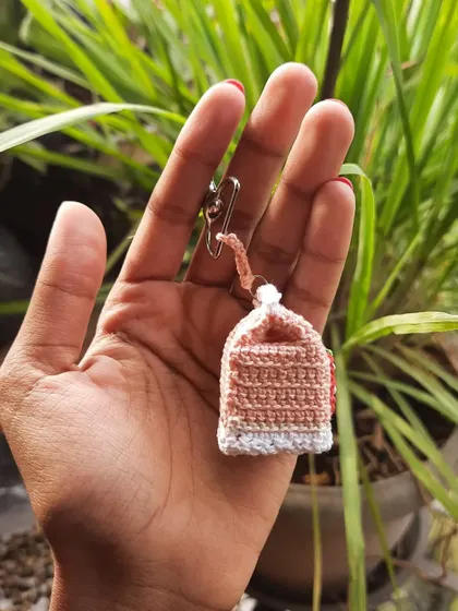 The back of the strawberry milk keychain, showing the clean construction and the small loop for the hardware.