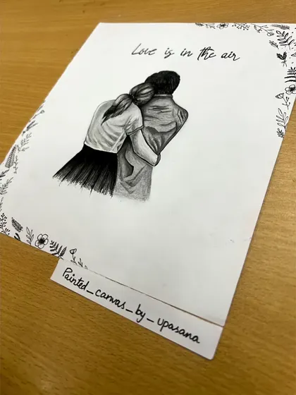 An angled shot of the custom couple sketch, showing the artwork on my desk. Each piece is hand-drawn on quality paper, ready to be framed.
