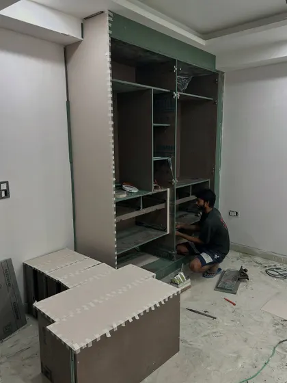 Another on-site photo of a wardrobe being built. The internal compartments for shelves and drawers are configured based on the client's specific storage requirements.
