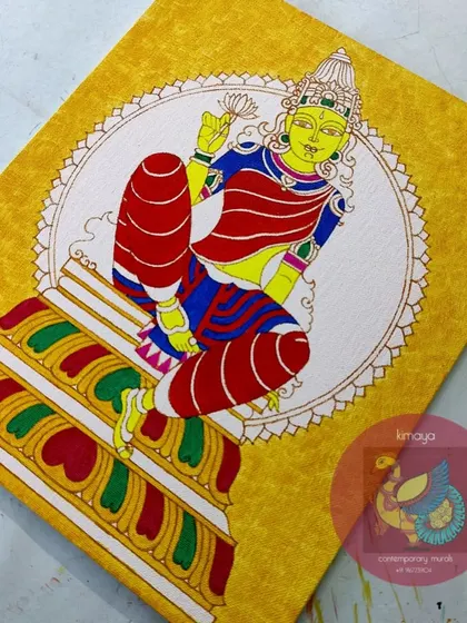 The Devi painting with the base colors of yellow, red, and blue applied. The composition is starting to take shape.