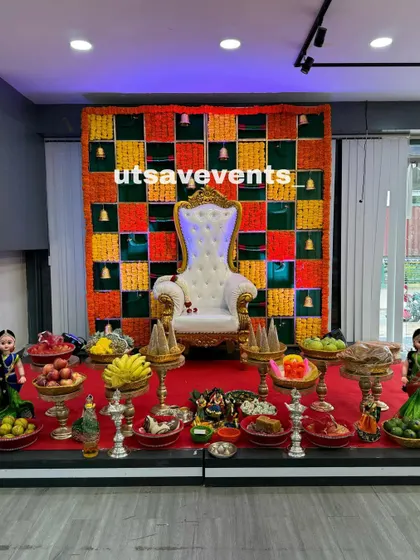 Another view of the traditional baby shower stage, showcasing the elaborate arrangement of fruits and sweets (plate decor) in front of the floral backdrop.