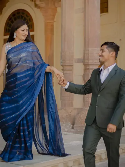 A "follow me" style shot on the steps of the fort. This playful and dynamic pose is great for creating a sense of movement and storytelling in your pre-wedding photos.