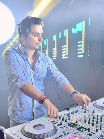 In the act at a white party, completely focused on the mix. This is a classic shot of me at work, crafting the perfect sound for the night.