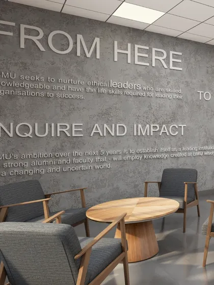 Wall graphics displaying the university's mission statement in the faculty lounge at BML Munjal University. We integrate institutional values directly into the design to reinforce a sense of purpose and community.