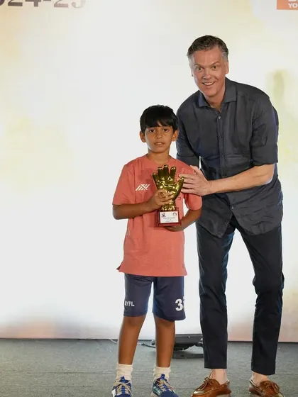 Krishna from our U9 team proudly accepts the Best Goalkeeper award. We train our keepers to be fearless and agile from a young age.